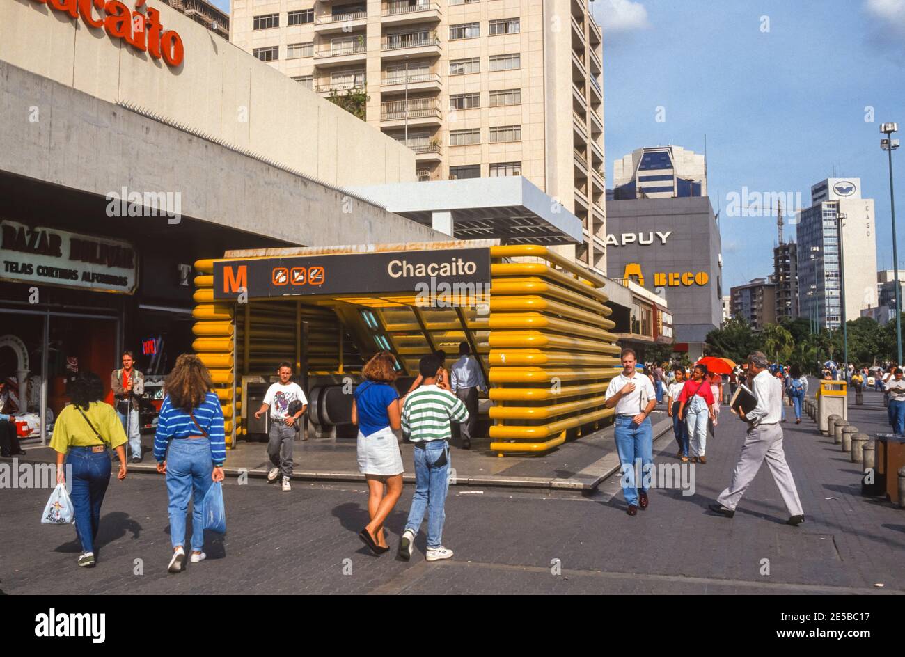 CARACAS, VENEZUELA, 1988 - Metro  entrance sign at Chacaito station, and people on sidewalk. Stock Photo