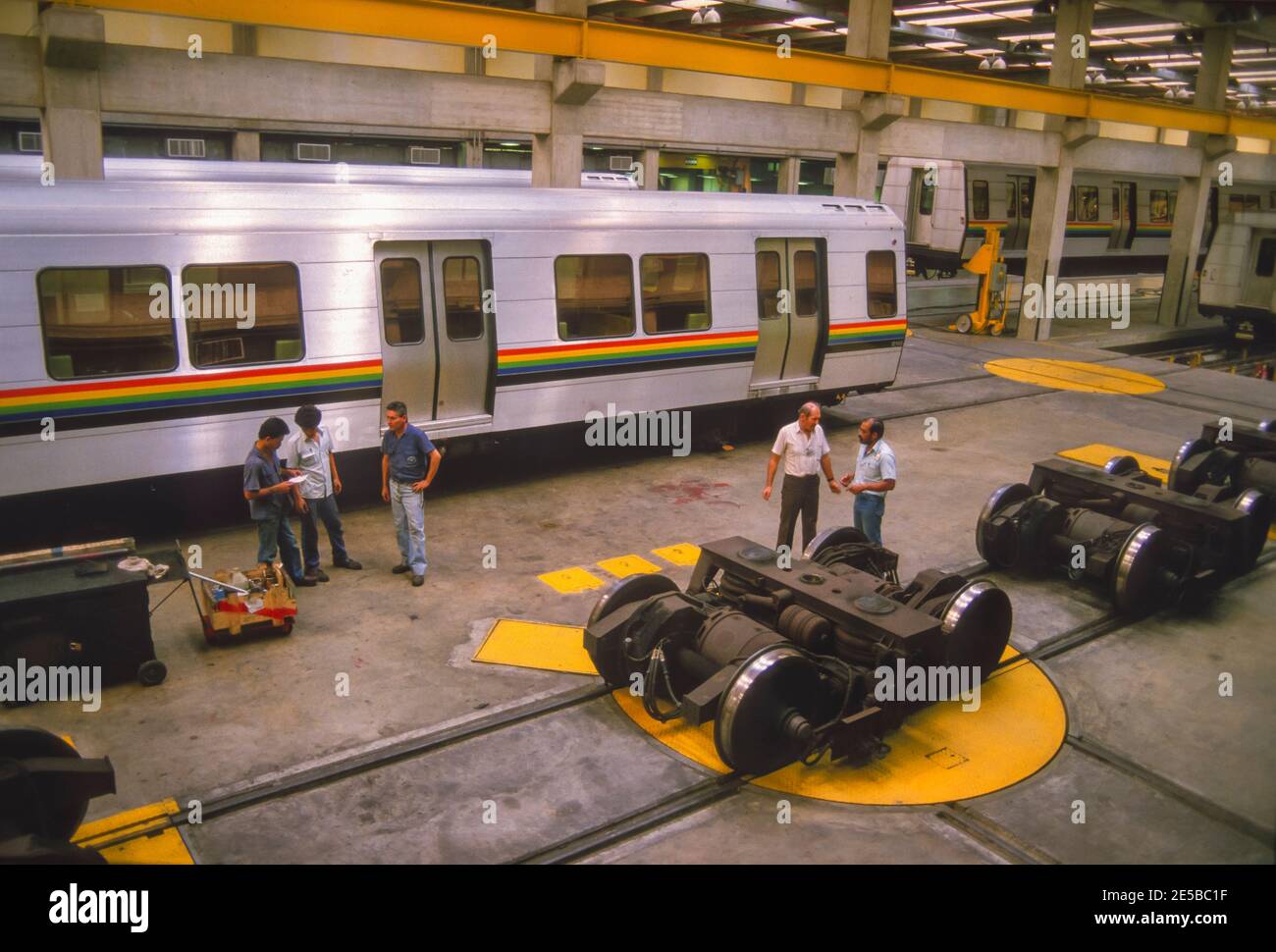 CARACAS, VENEZUELA, 1988 - Metro train repair and maintanance shop and workers. Stock Photo