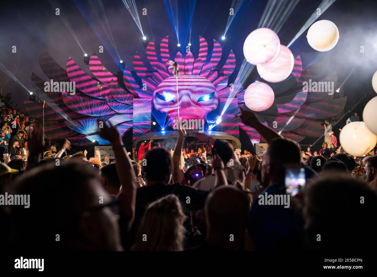Festival goers dance inside the Temple, an all night venue in the South East corner of Glastonbury at Worthy Farm, Pilton, Somerset. Stock Photo