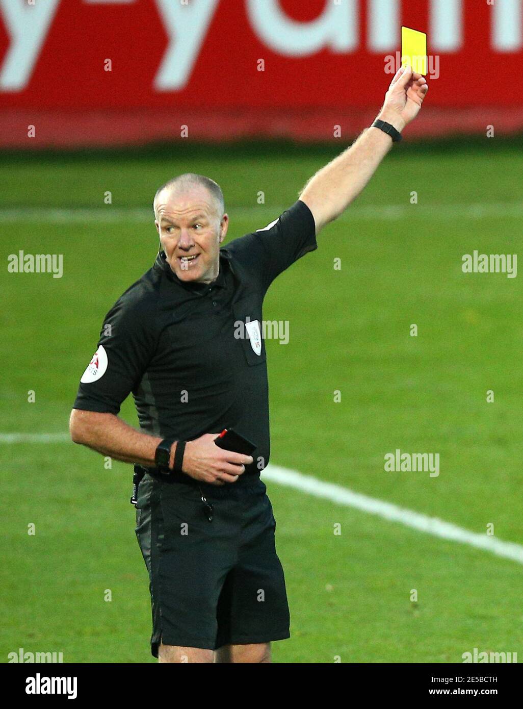 Match referee Graham Salisbury shows a yellow card Stock Photo Alamy
