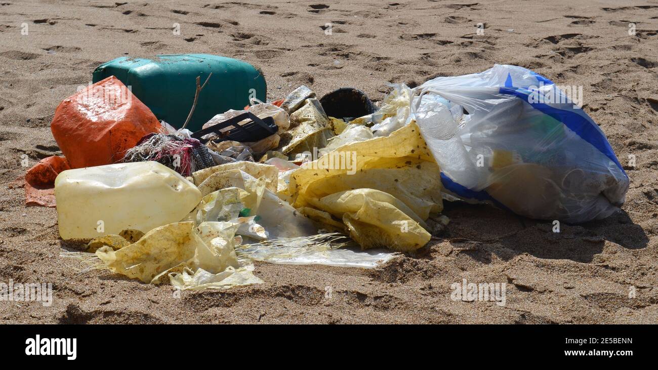 Collection of washed up plastic garbage on the sand Stock Photo