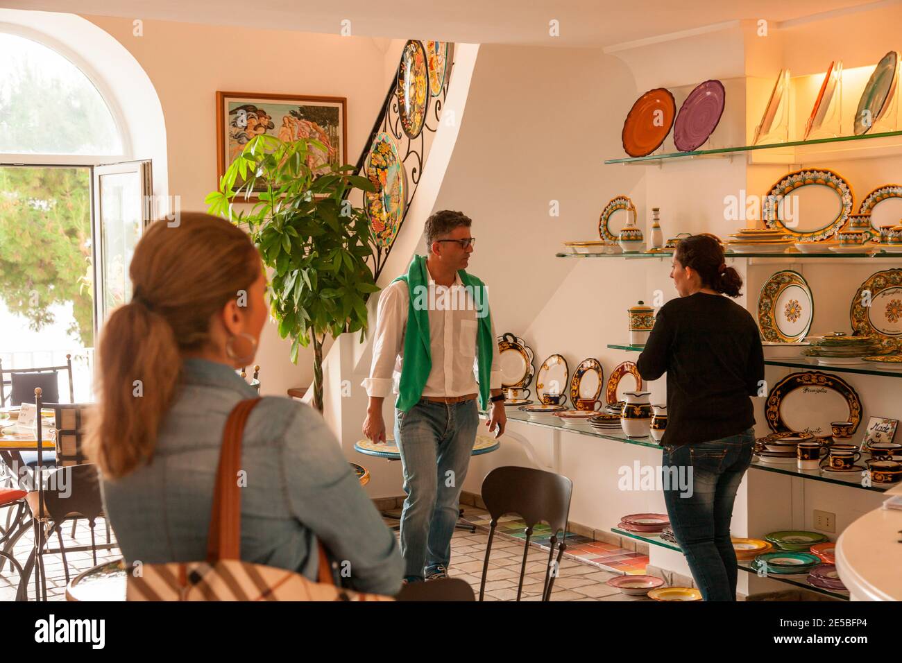 An Italian couple are shown ceramic pieces in a shop in Portofino, Italy. Stock Photo