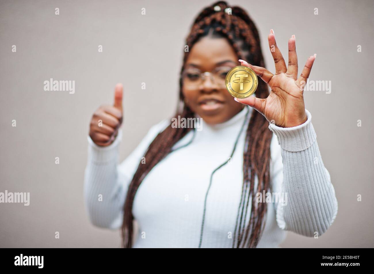 African american business woman show Tether coin and thumb up.  Cryptocurrency concept Stock Photo - Alamy