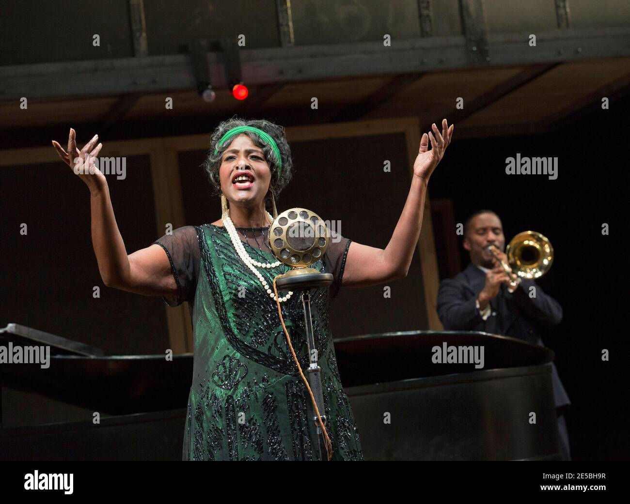 Sharon D Clarke (Ma Rainey) with Clint Dyer (Cutler - on trombone) in MA RAINEY'S BLACK BOTTOM by August Wilson at the Lyttelton Theatre, National Theatre (NT), London SE1  02/02/2016  design: Ultz  lighting: Charles Balfour  director: Dominic Cooke Stock Photo