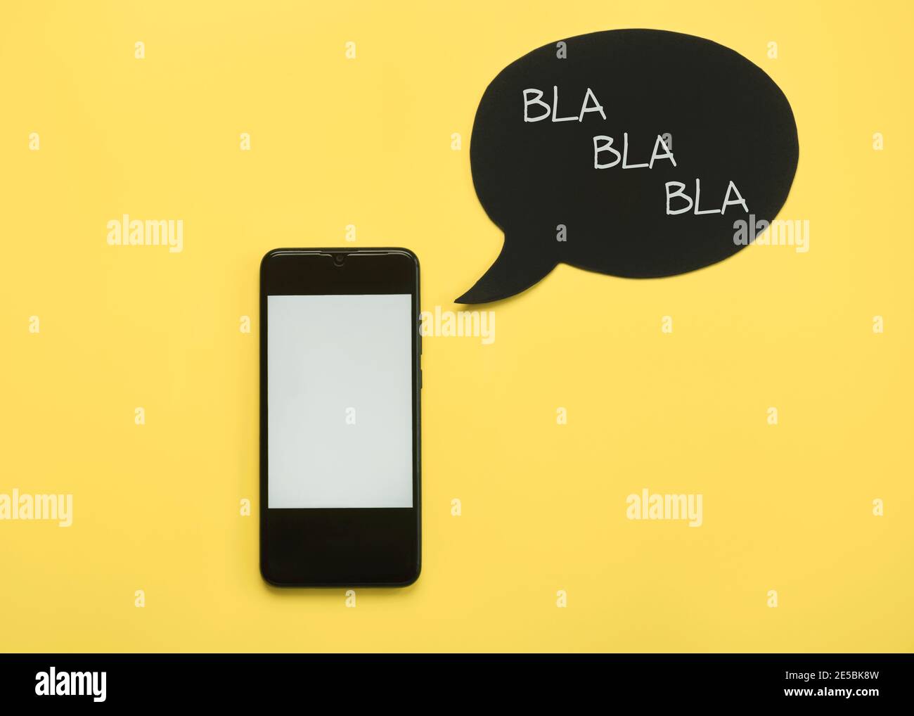 Smartphone with speech bubble on yellow background Stock Photo