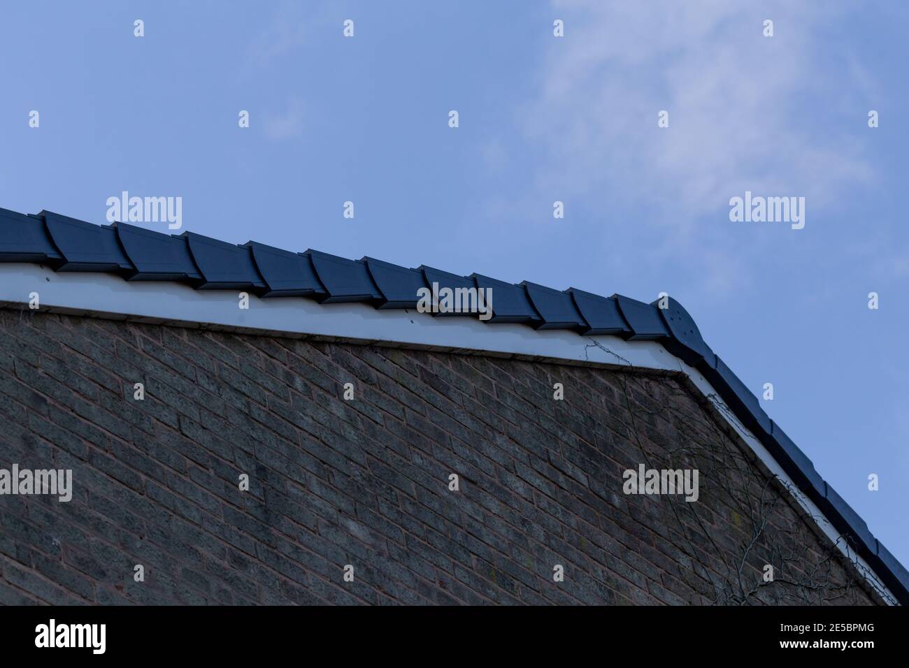 A dry verge system on the roof of a house. Stock Photo