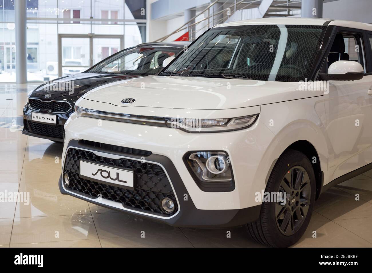 Russia, Izhevsk - December 28, 2020: KIA showroom. New Ceed SW and Soul in dealer showroom. Front and side view. Famous world brand. Stock Photo