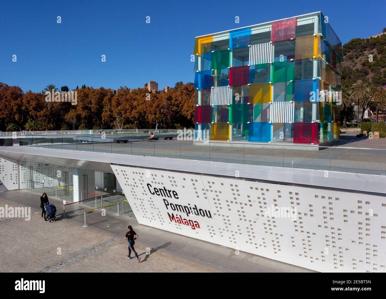 Centre Pompidou Malaga Contemporary Modern Art Museum Malaga Spain Europe one woman pushing a pram and another woman running away along Muelle Uno Stock Photo