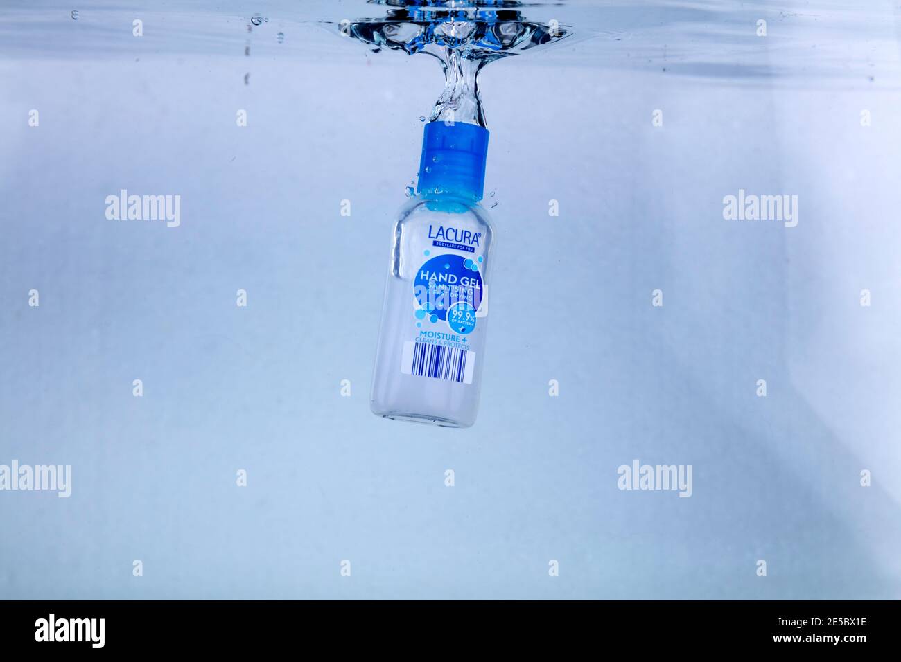 Hi speed shot of a bottle of hand sanitiser dropping into water