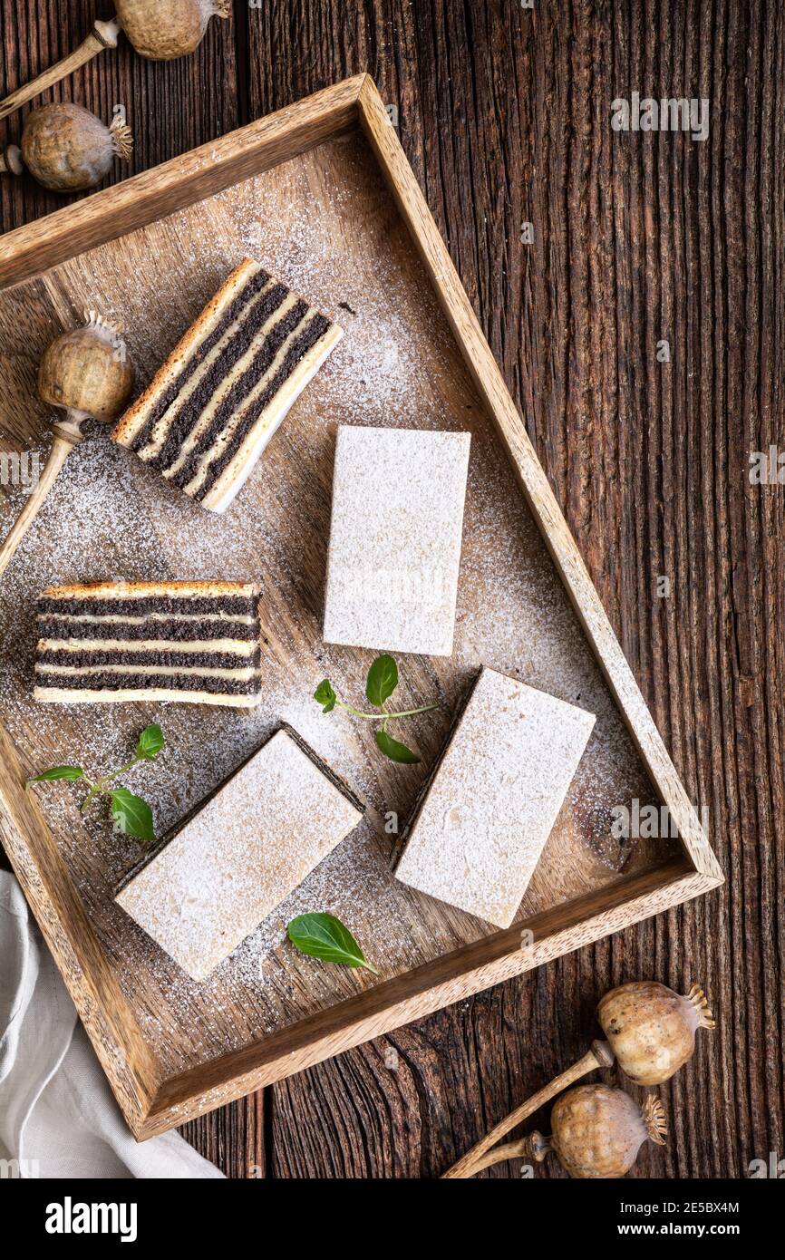 Sweet dessert, layered poppy seed cake dusted with powdered sugar Stock Photo