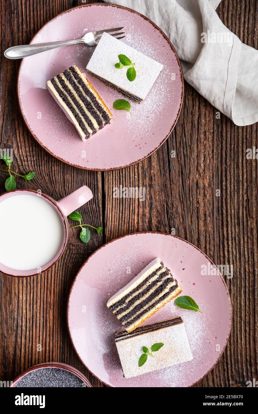 Sweet dessert, layered poppy seed cake dusted with powdered sugar Stock Photo