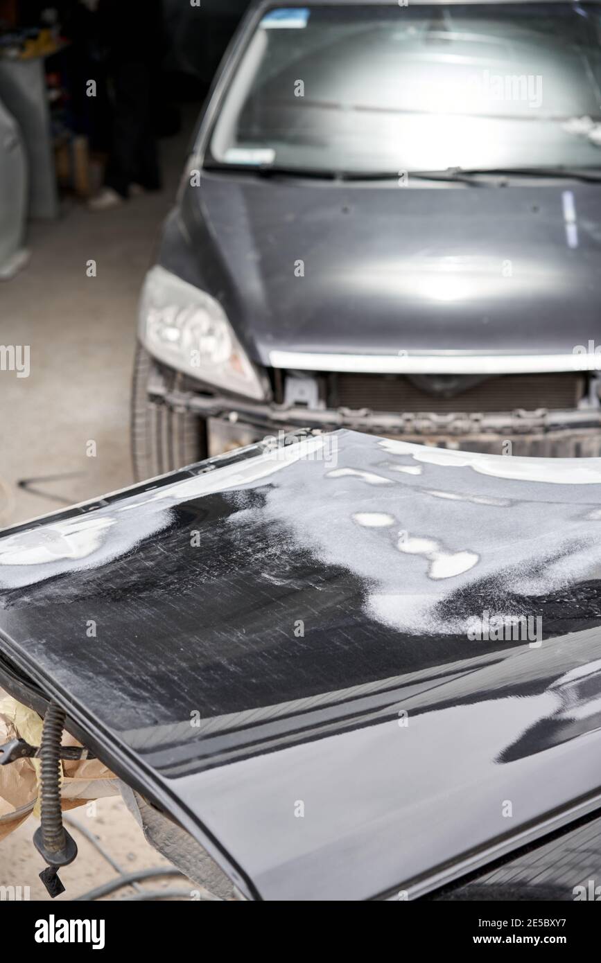 Repairing car body, Application putty close up. The mechanic repair the car. Work after the