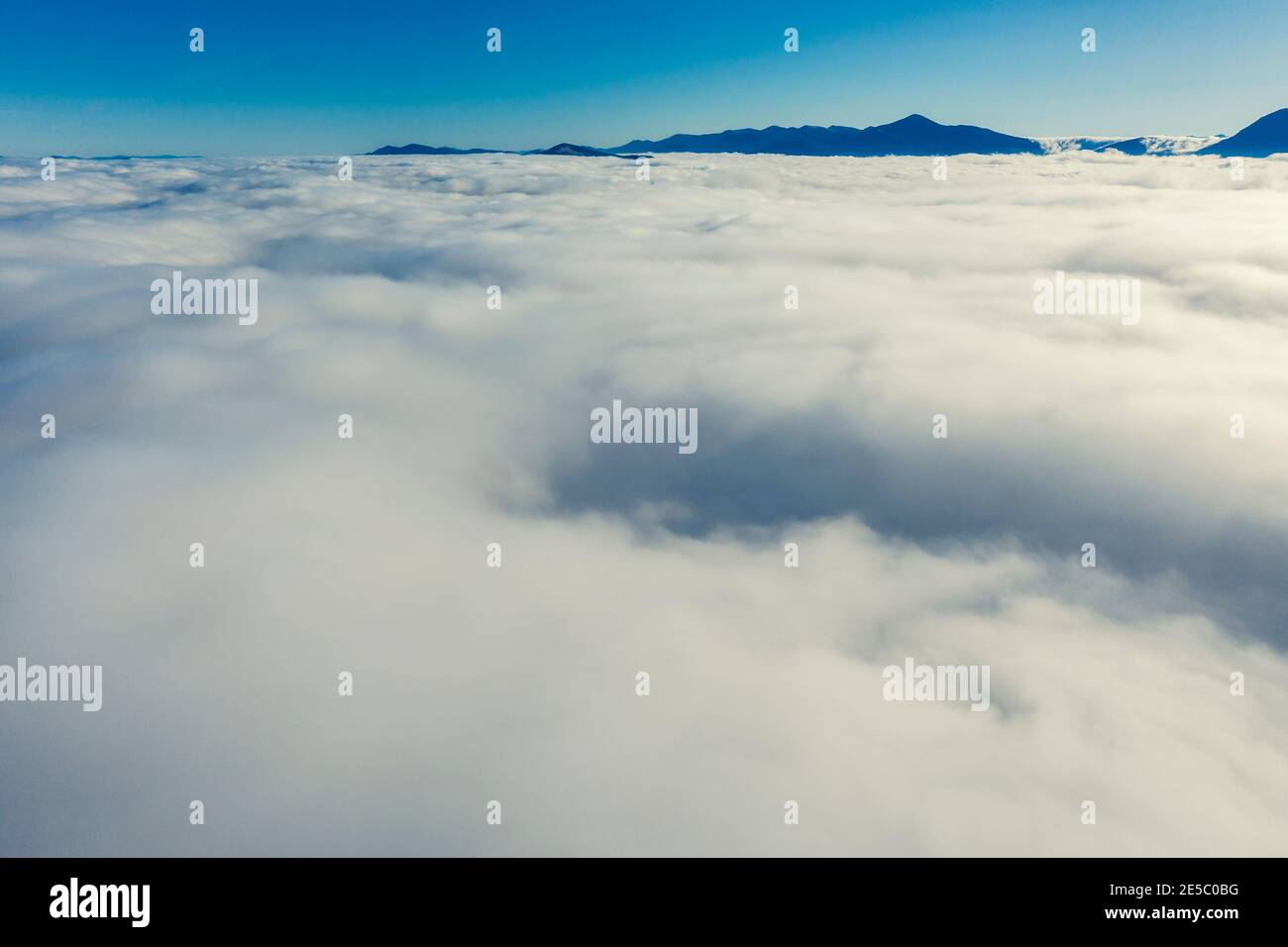 Fantastic views of the mountain ridge tops above the clouds Stock Photo ...