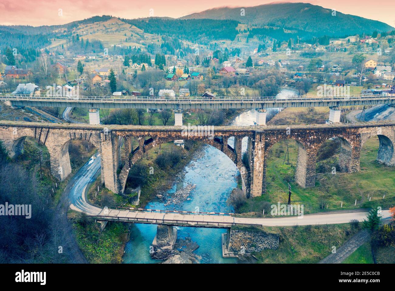 Panoramic view of the city of Vorokhta in the mountain valley. Three bridges over the Prut river. View of the road bridge and two railway bridges Stock Photo