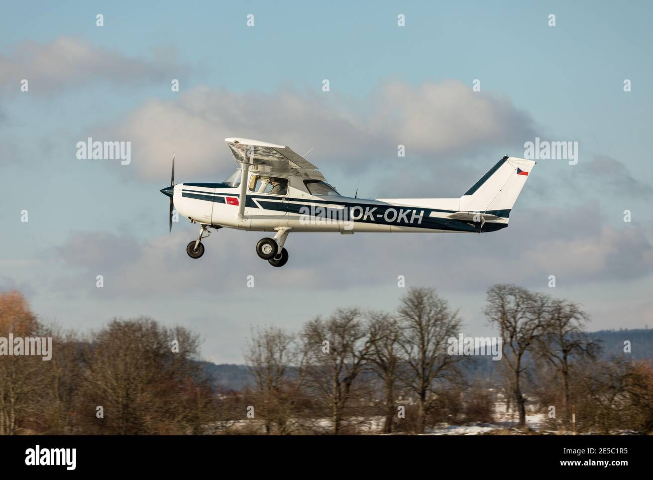 DLOUHA LHOTA, CZECH REP - JAN 27, 2021. Small sport airplane Cessna 150 on a background of blue sky. Stock Photo