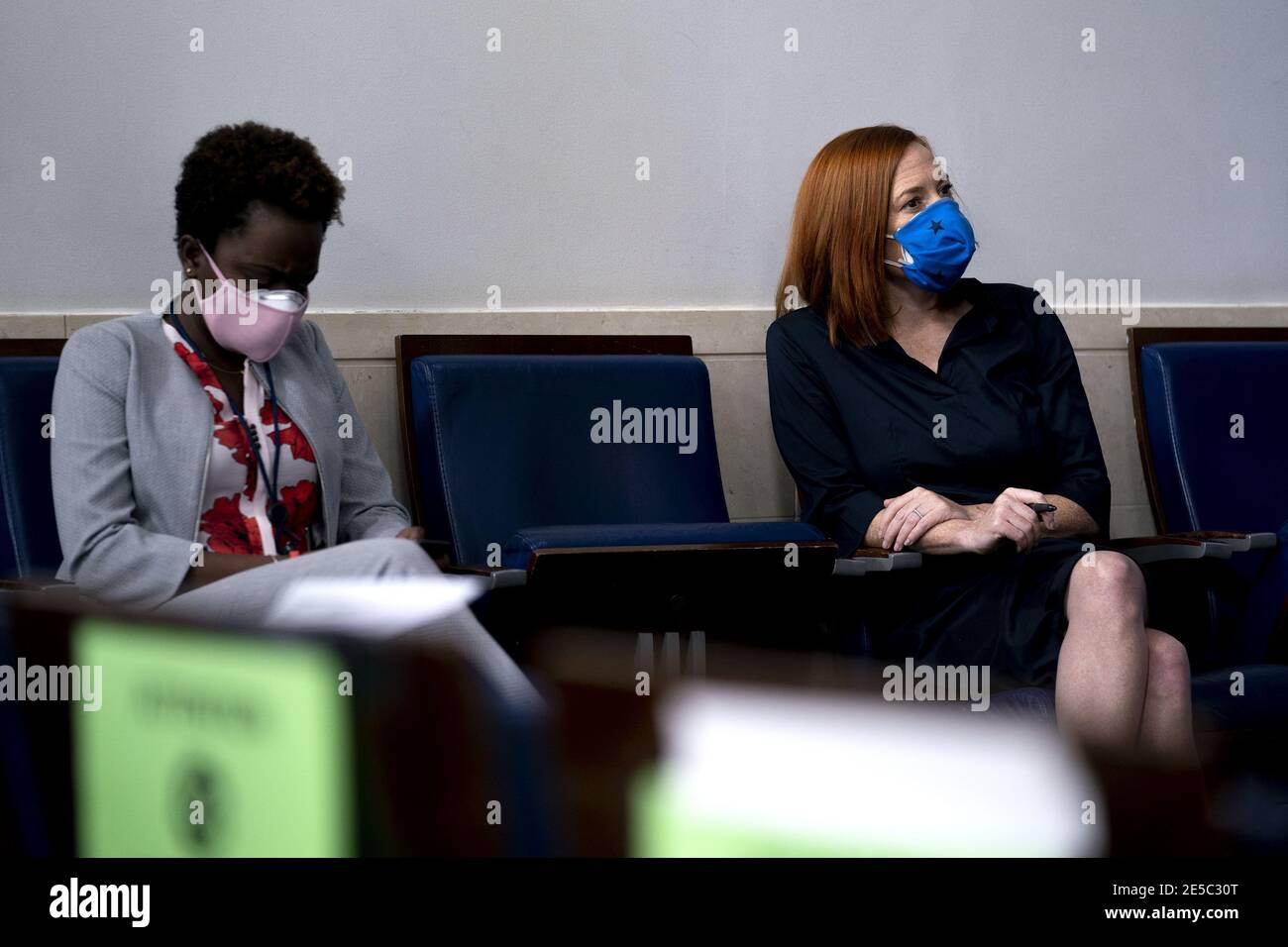 Karine Jean-Pierre, White House deputy press secretary, left, and Jen Psaki, White House press secretary, wear protective masks while listening during a news conference in the James S. Brady Press Briefing Room at the White House in Washington, DC on Wednesday, January 27, 2021. U.S. President Joe Biden will take executive action on Wednesday to combat climate change, including temporarily blocking new leases for oil drilling on federal lands, ordering a review of fossil-fuel subsidies and other measures to overhaul the U.S. energy mix. Photo by Stefani Reynolds/UPI Stock Photo