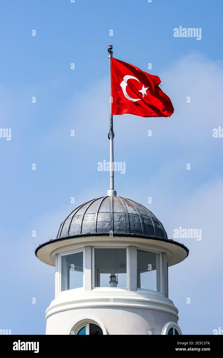 Flag of Turkey fluttering above lighthouse or beacon in Alanya, Turkey Stock Photo