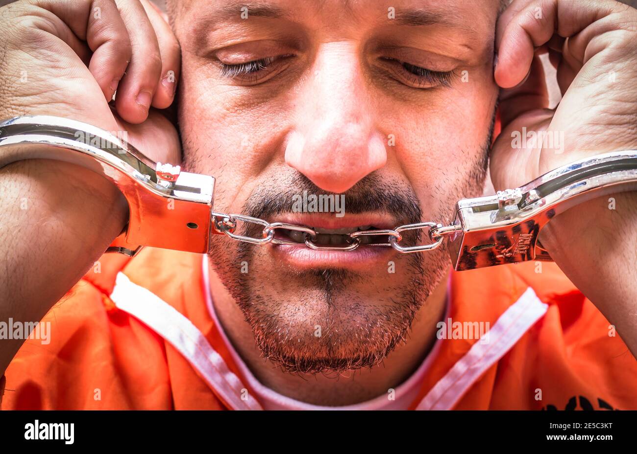 Prisoner with handcuffs detained in prison jailhouse Stock Photo