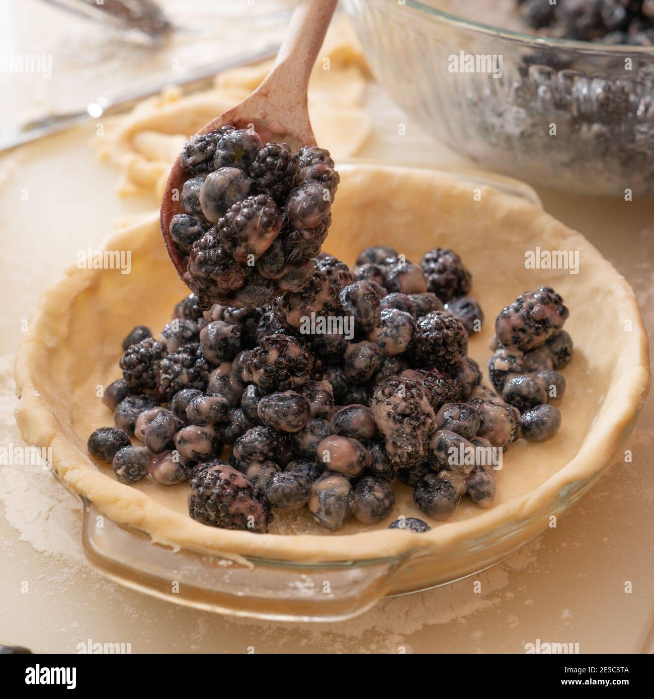 filling pie crust with berries Stock Photo