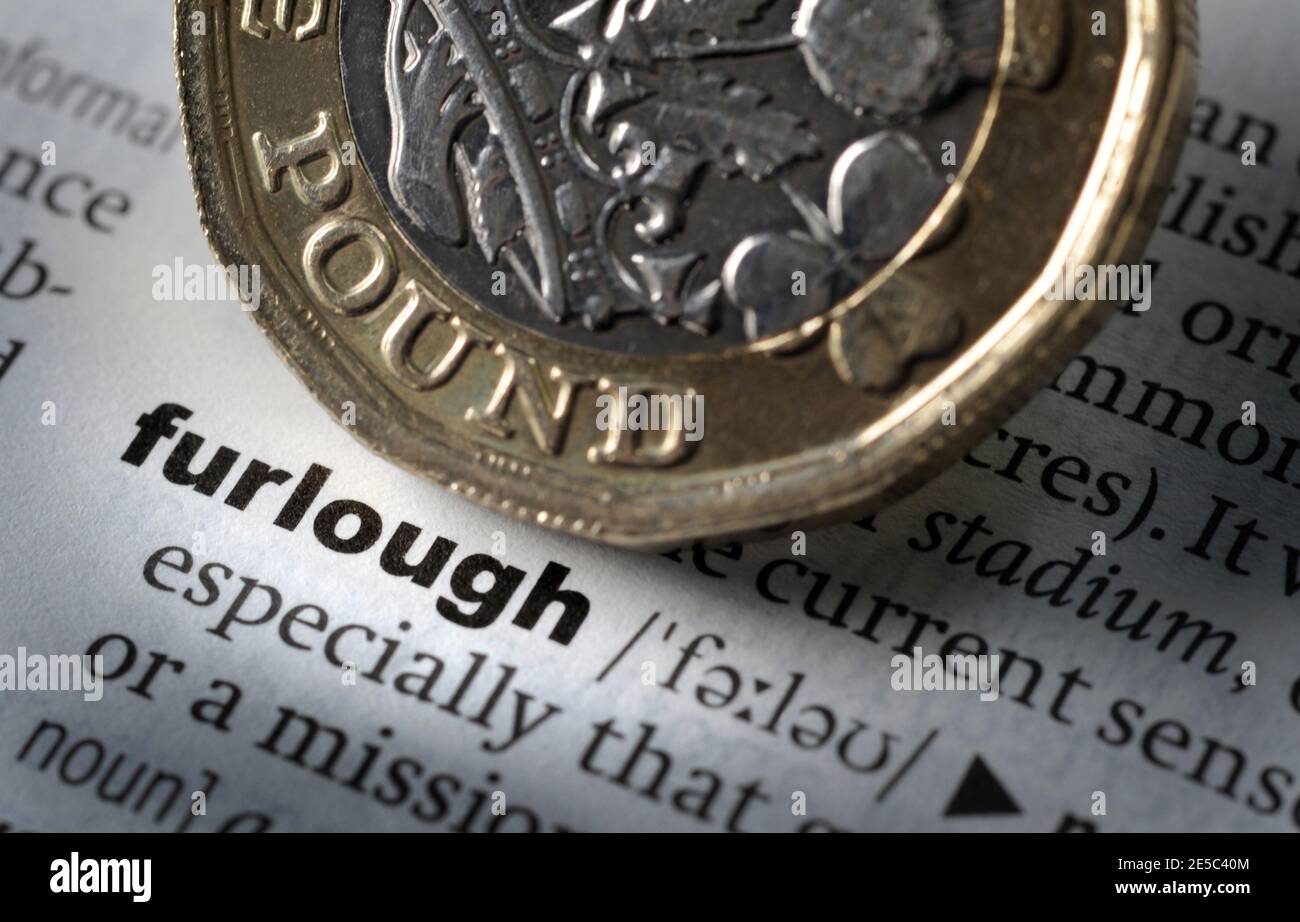 DICTIONARY DEFINITION OF WORD FURLOUGH WITH ONE POUND COIN RE COVID 19 CORONAVIRUS WORKERS UNEMPLOYMENT FURLOUGH SCHEME ETC UK Stock Photo