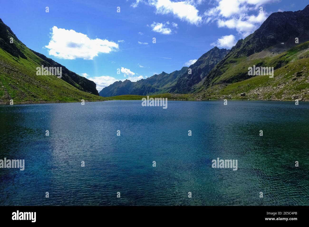 deep blue water from a mountain lake in the summer on vacation Stock Photo