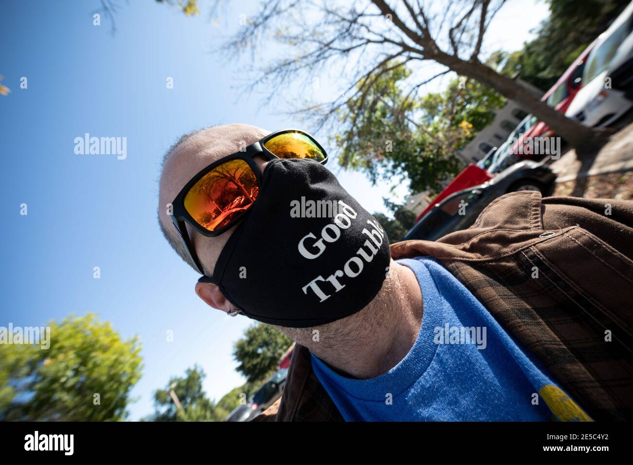Man wearing Good Trouble mask and sunglasses. Stock Photo