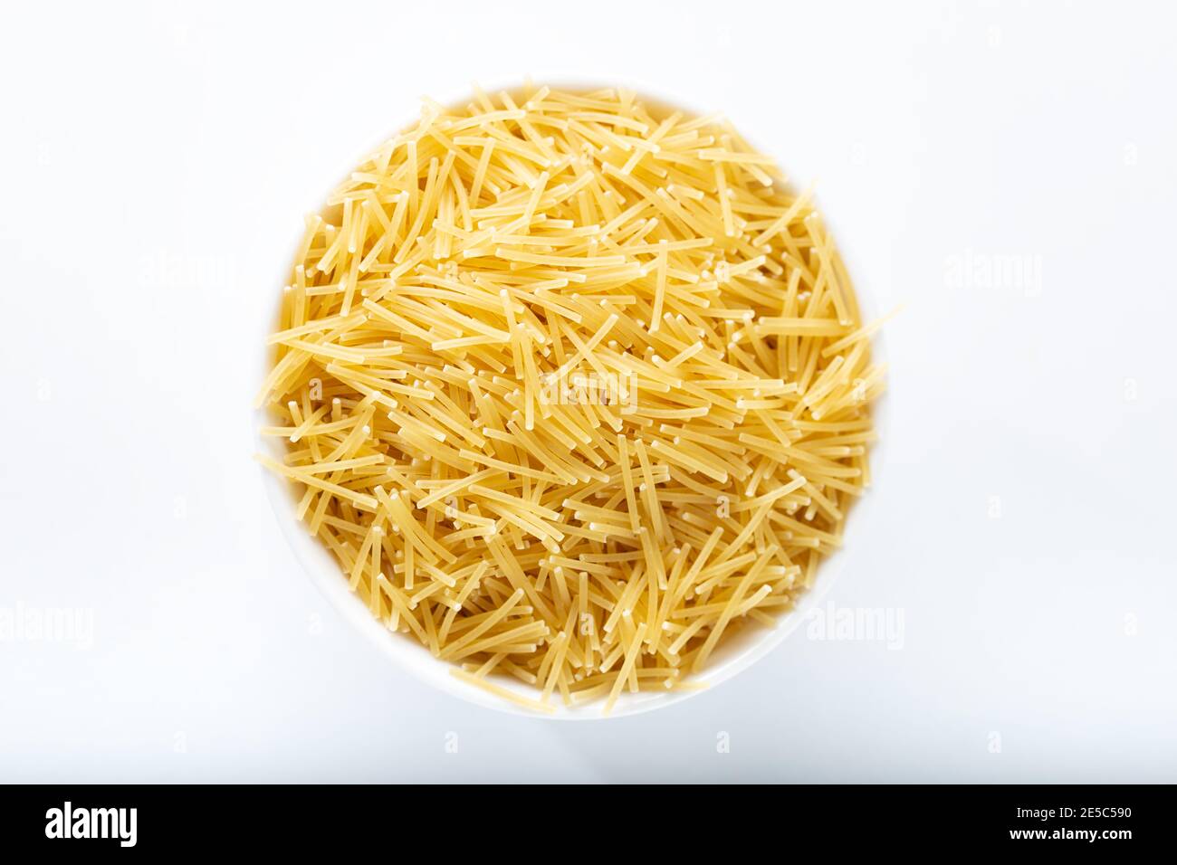 Bowl of uncooked vermicelli pasta isolated on white background Stock