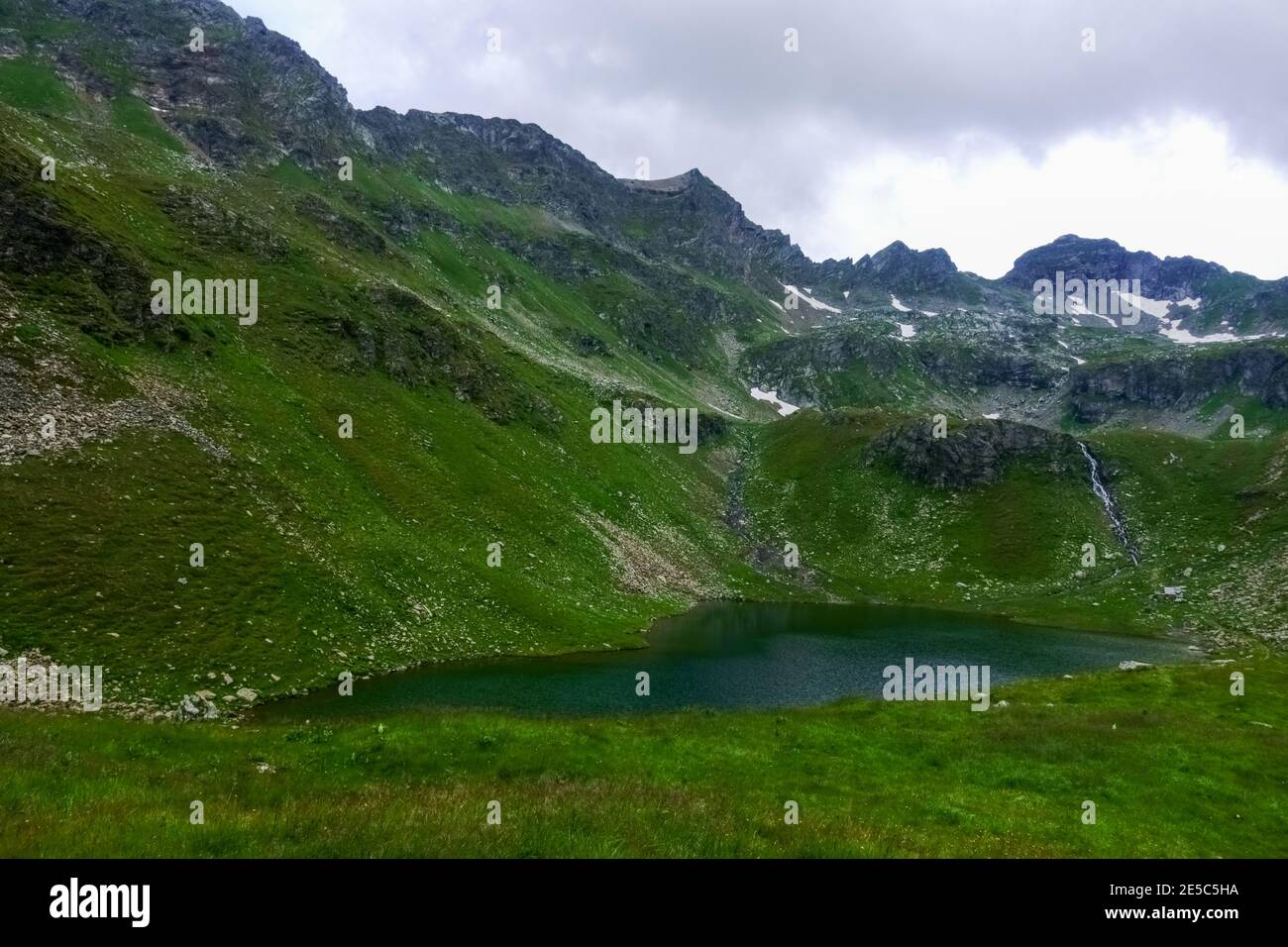 little beautiful mountain lake in the middle of green mountains on vacation Stock Photo