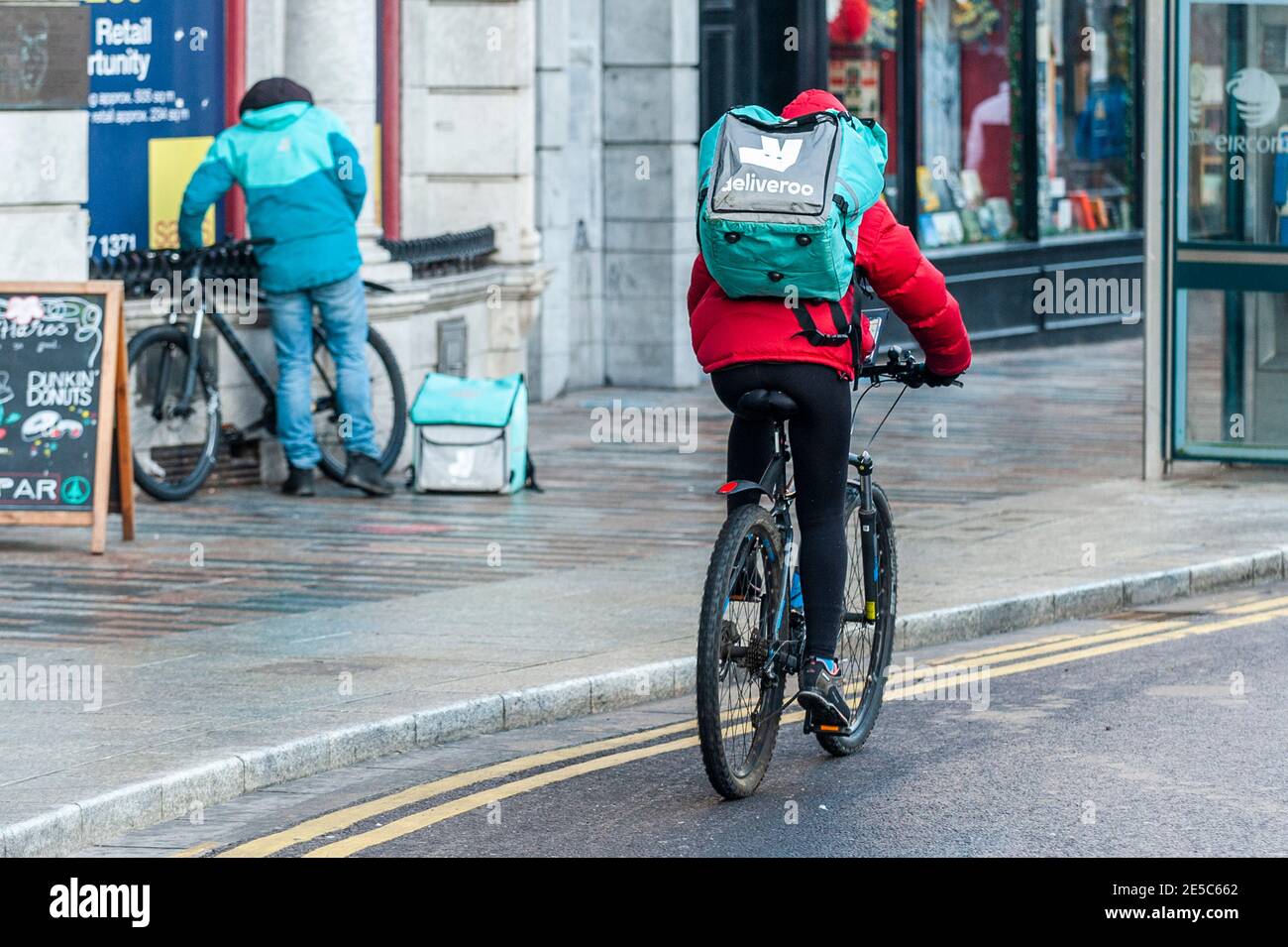 Deliveroo food delivery riders in Cork city, Ireland Stock Photo Alamy