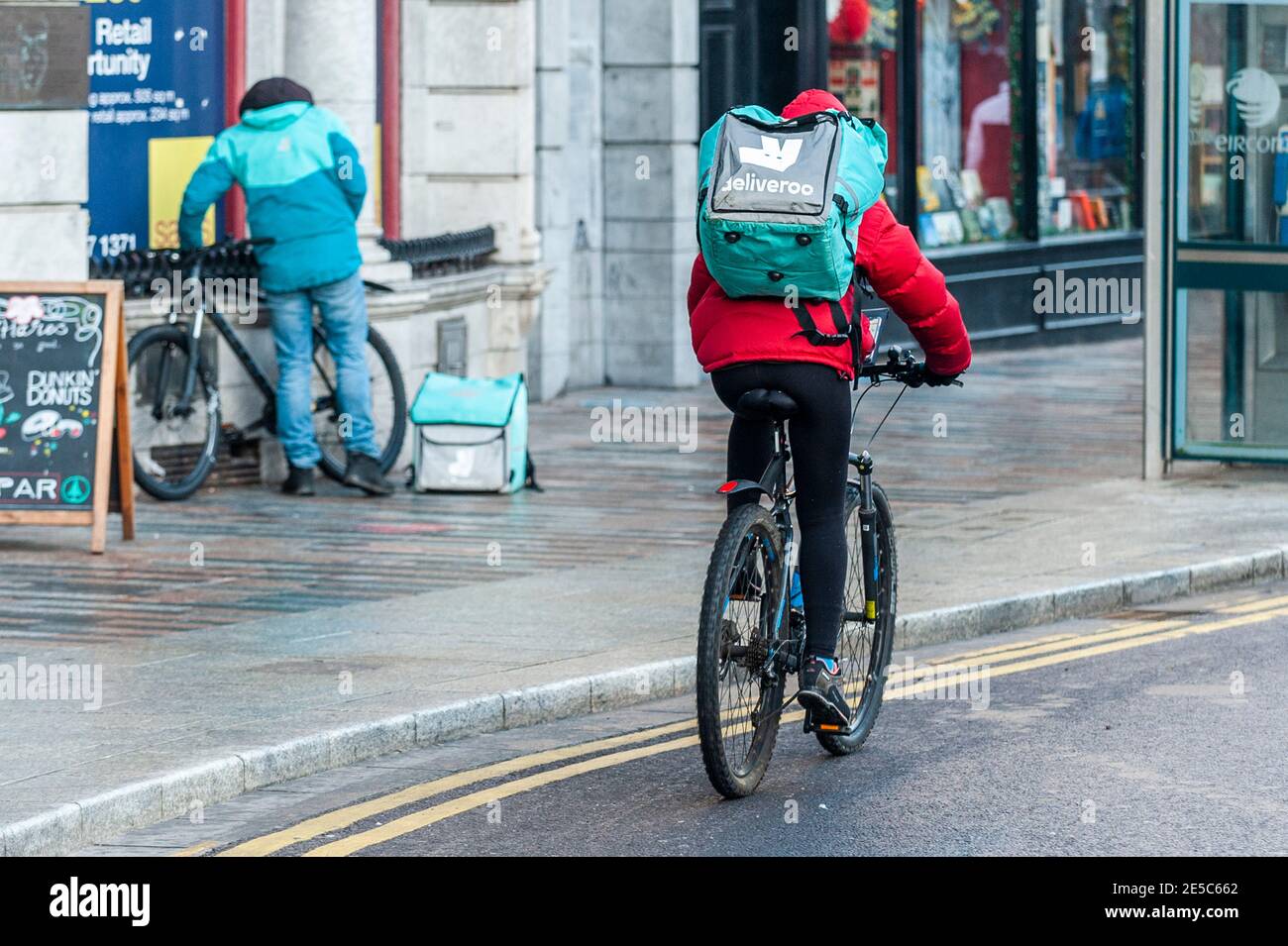Deliveroo food delivery riders in Cork city, Ireland. Stock Photo