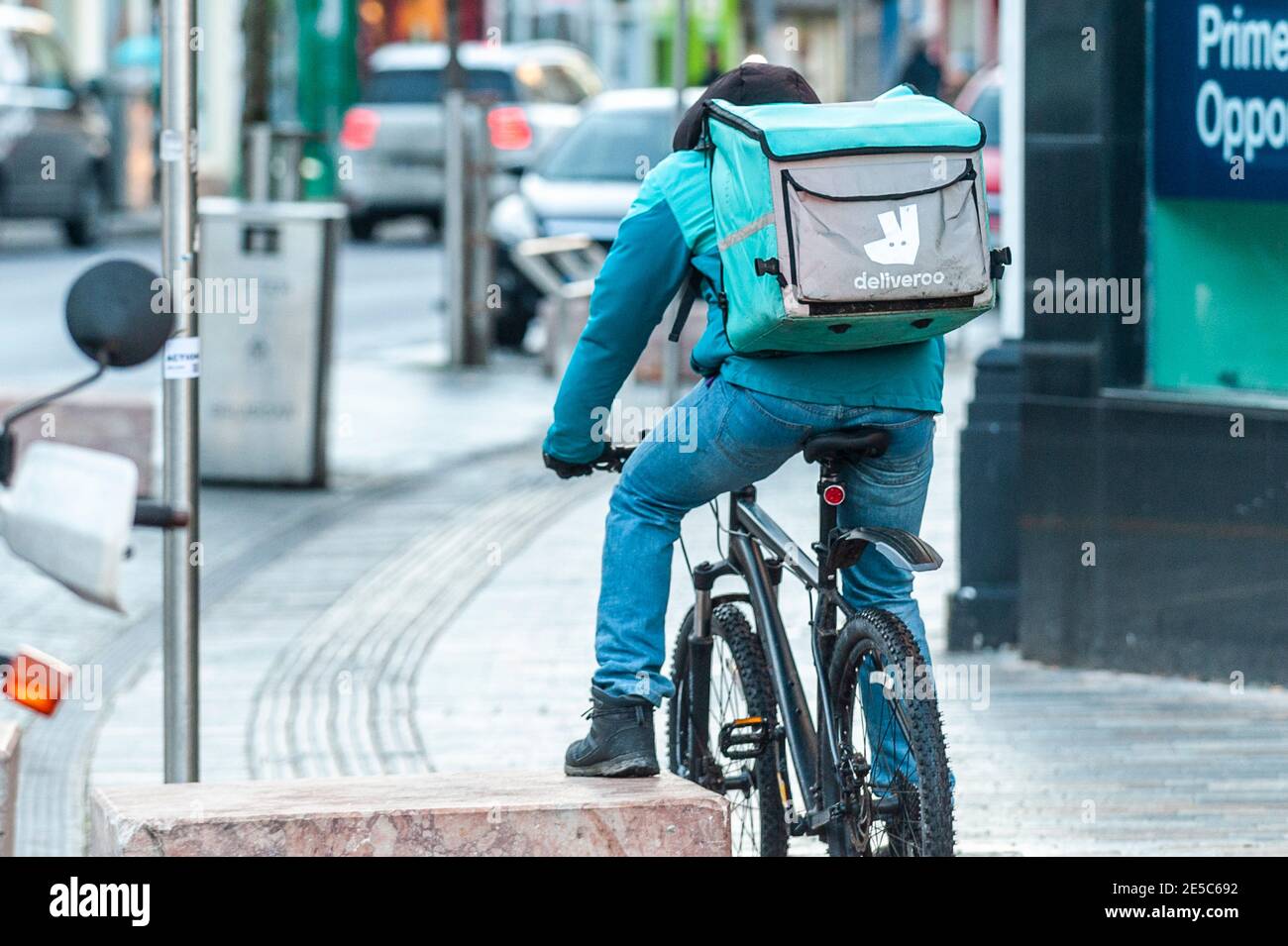 Deliveroo food delivery rider in Cork city, Ireland. Stock Photo
