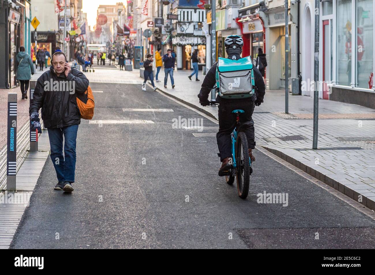 Deliveroo food delivery rider in Cork city, Ireland. Stock Photo