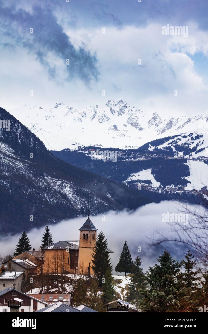 Panorama with Church in Champagny-en-Vanoise village in France and view on Courchevel at winter Stock Photo