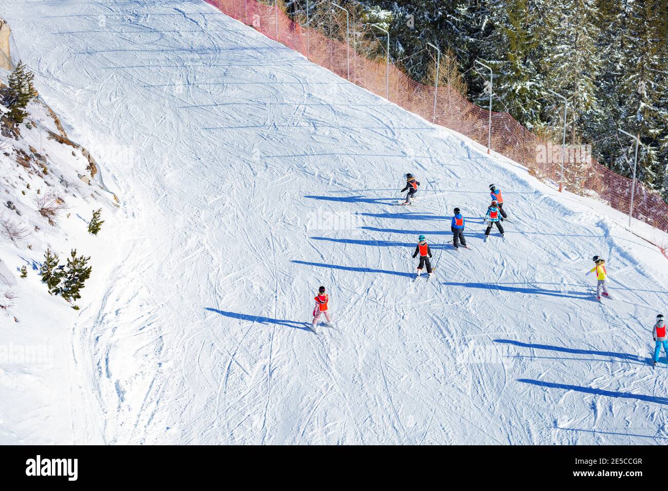 Group of ski school kids ride exercising in class from above Stock Photo
