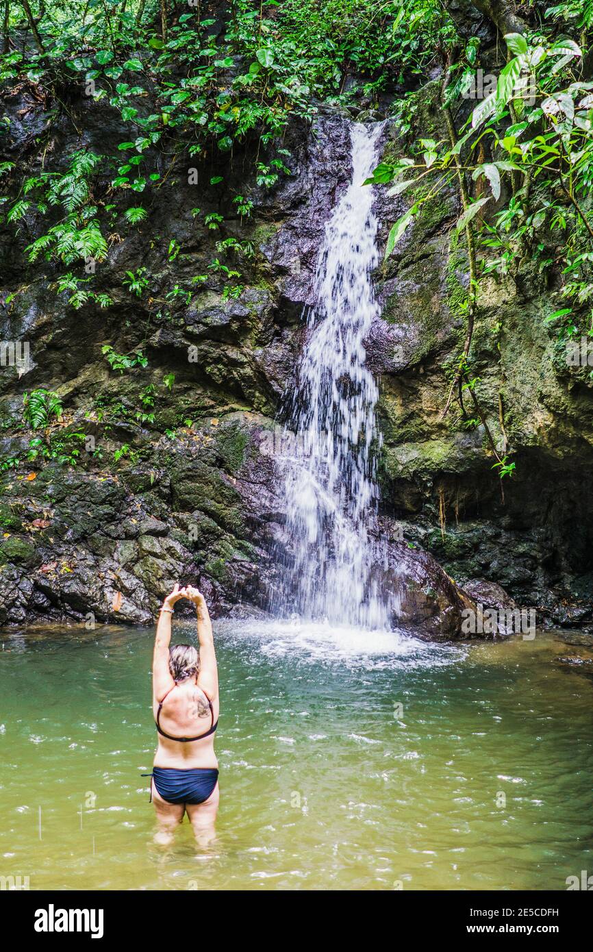 Middle aged female at natural waterfall in Costa rican jungle, Costa