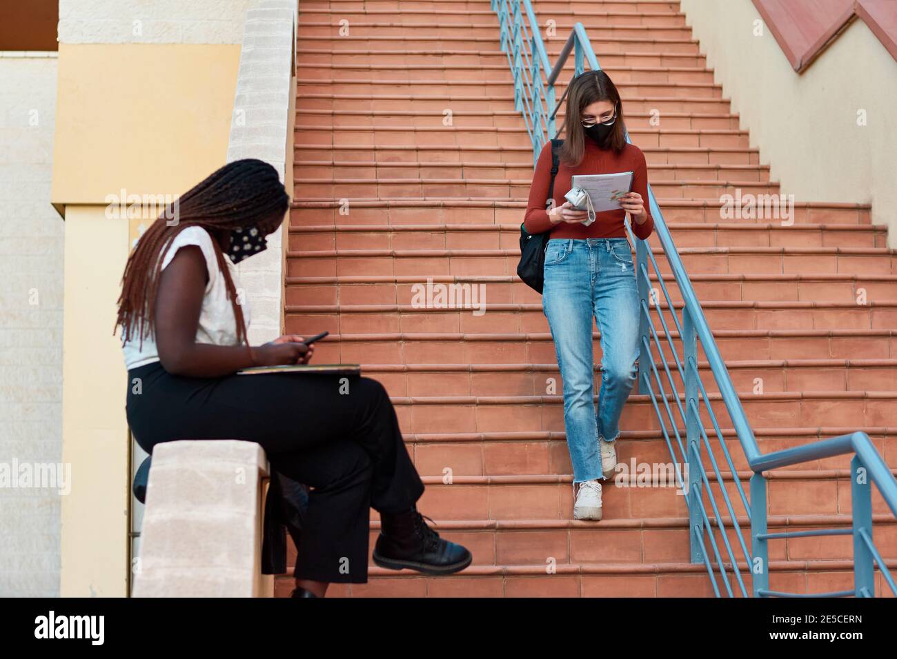 Two young students are on a university campus. Multiethnic concept Stock Photo