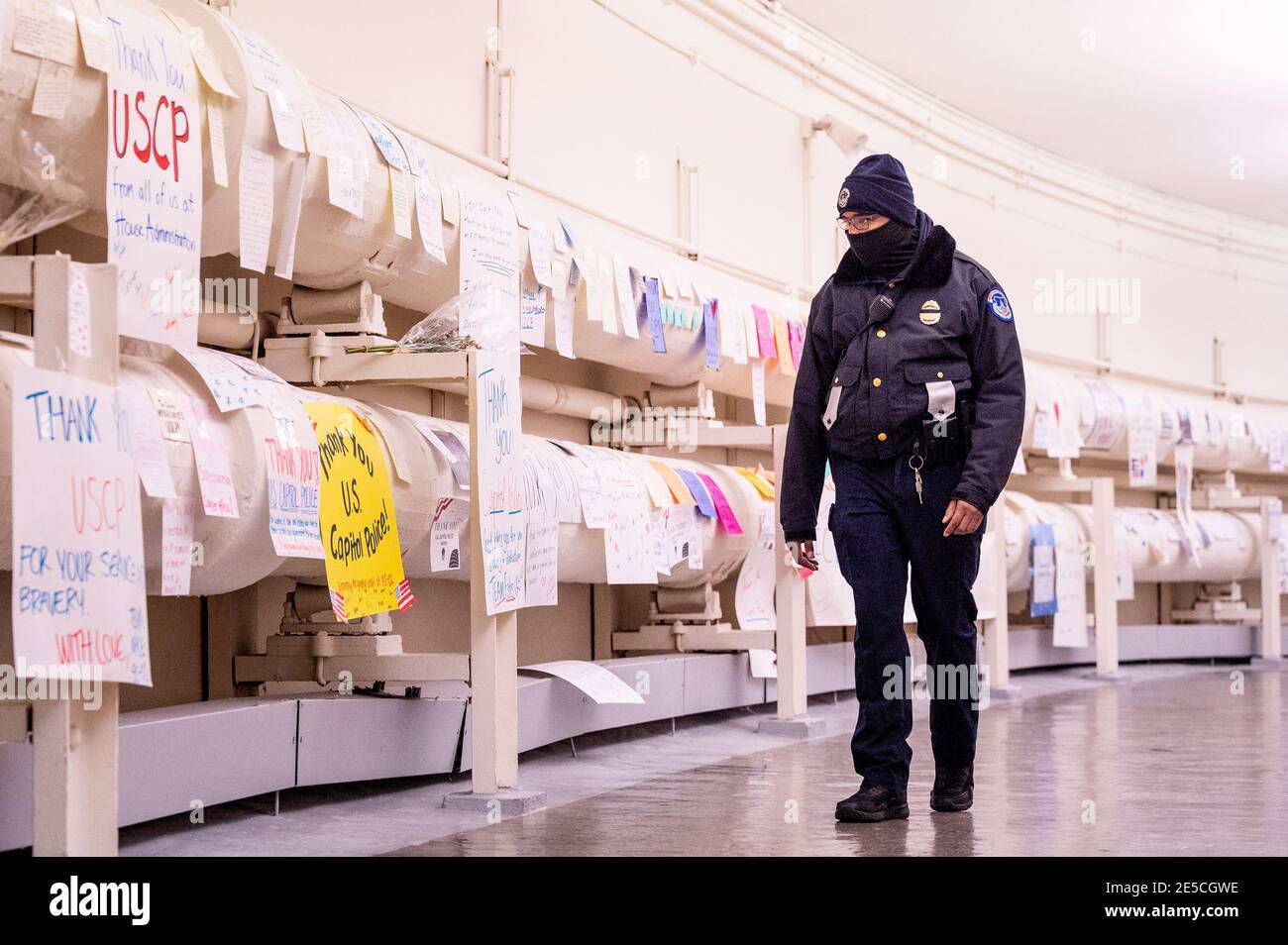 A United States Capitol Police officer walks by signs of gratitude for ...
