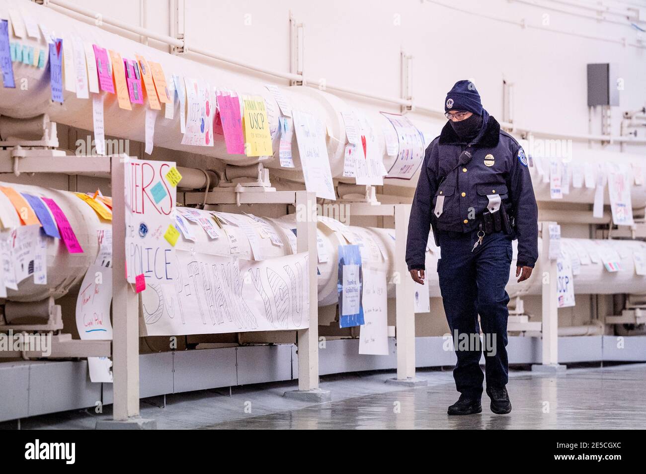 A United States Capitol Police officer walks by signs of gratitude for ...