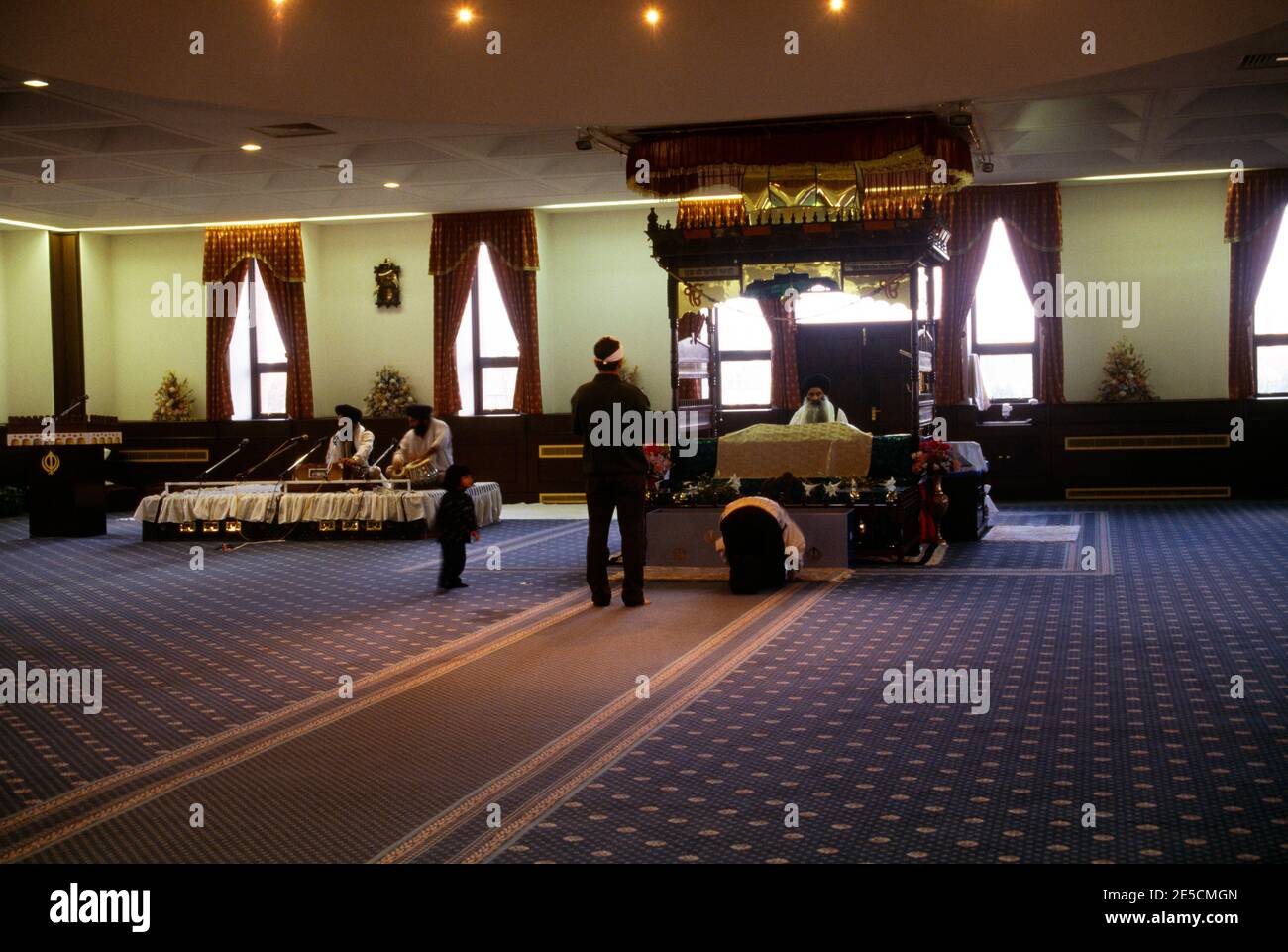 London England Sikh Funeral Granthi In Black Reading Sri Guru Granth