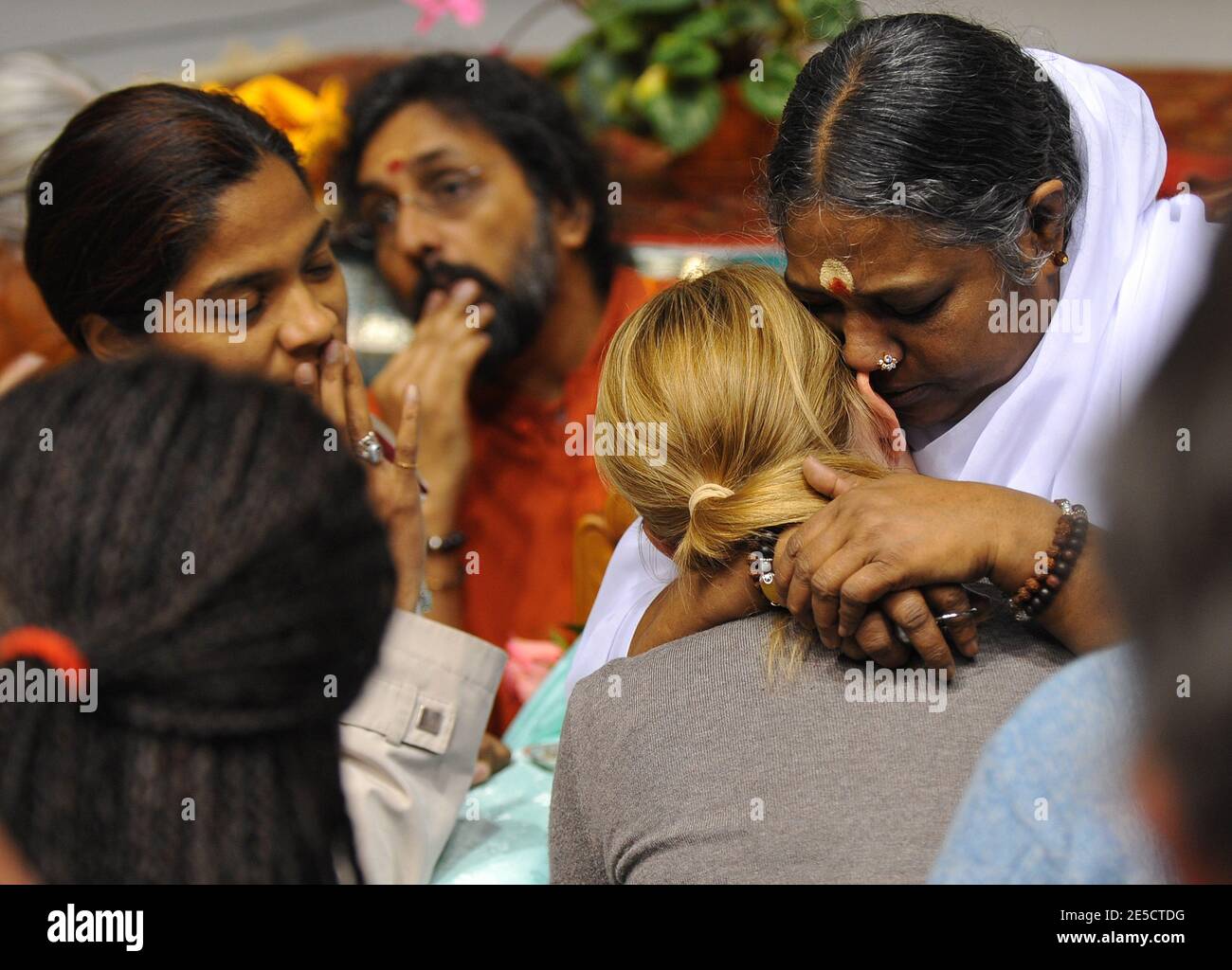 Indian spiritual leader Mata Amritanandamayi as known as Amma hugs a woman  in Cergy-Pontoise, near Paris, France on October 24, 2008, during a few  days trip in France. Amma offers a hug
