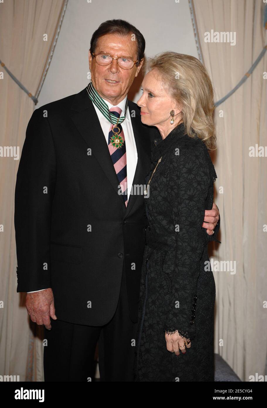 Sir Roger Moore, accompagned by his wife Kristina Tholstrup, receiving the Chevalier of Arts and Literature medal at the Ministry of Culture in Paris, France on October 28, 2008. Photo by Thierry Orban/ABACAPRESS.COM Stock Photo