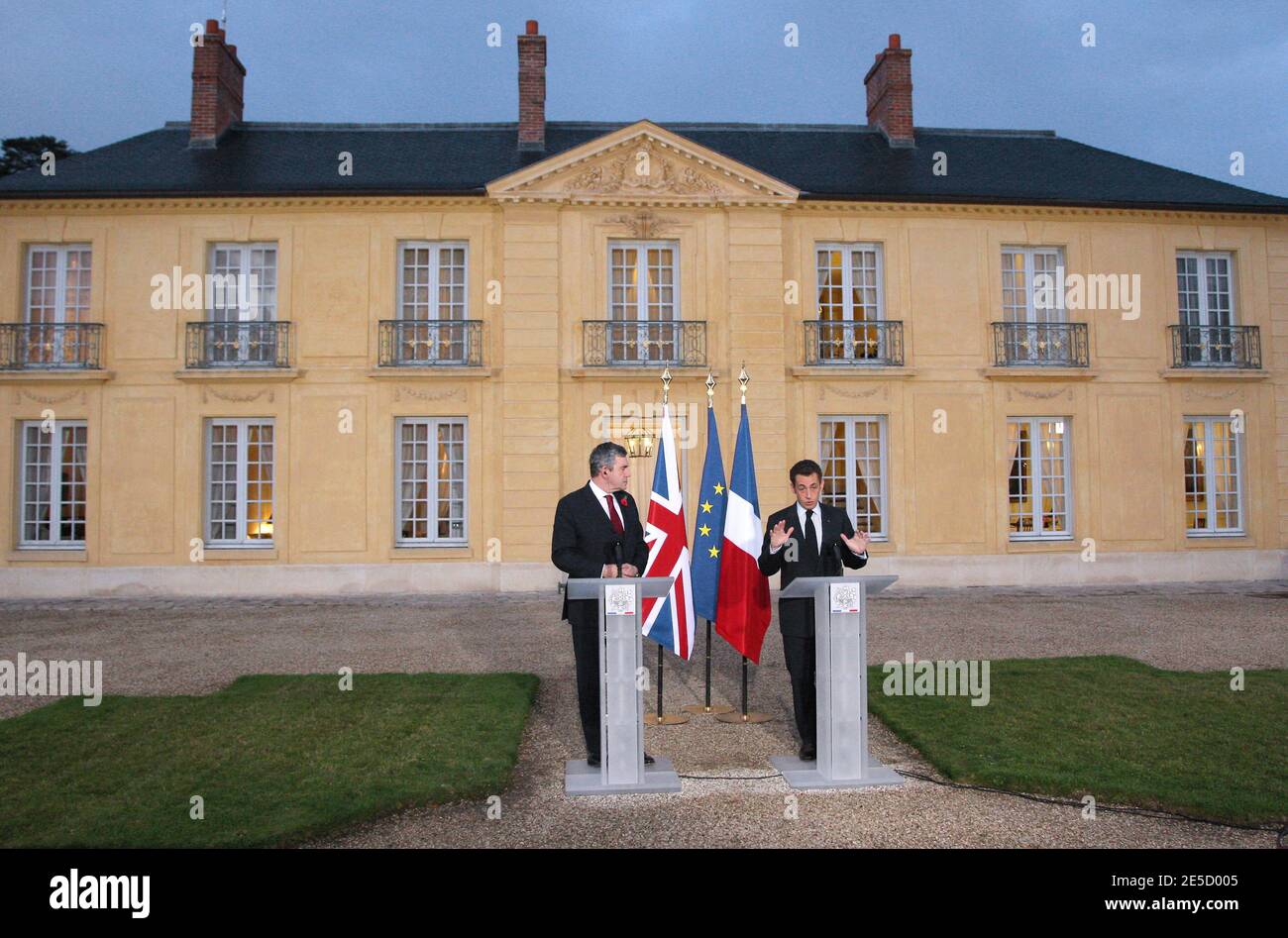 French President Nicolas Sarkozy (R) delivers a speech next to Britain's  Prime Minister Gordon Brown (L) at the presidential residence at La Lanterne,  in an estate associated with the Chateau de Versailles