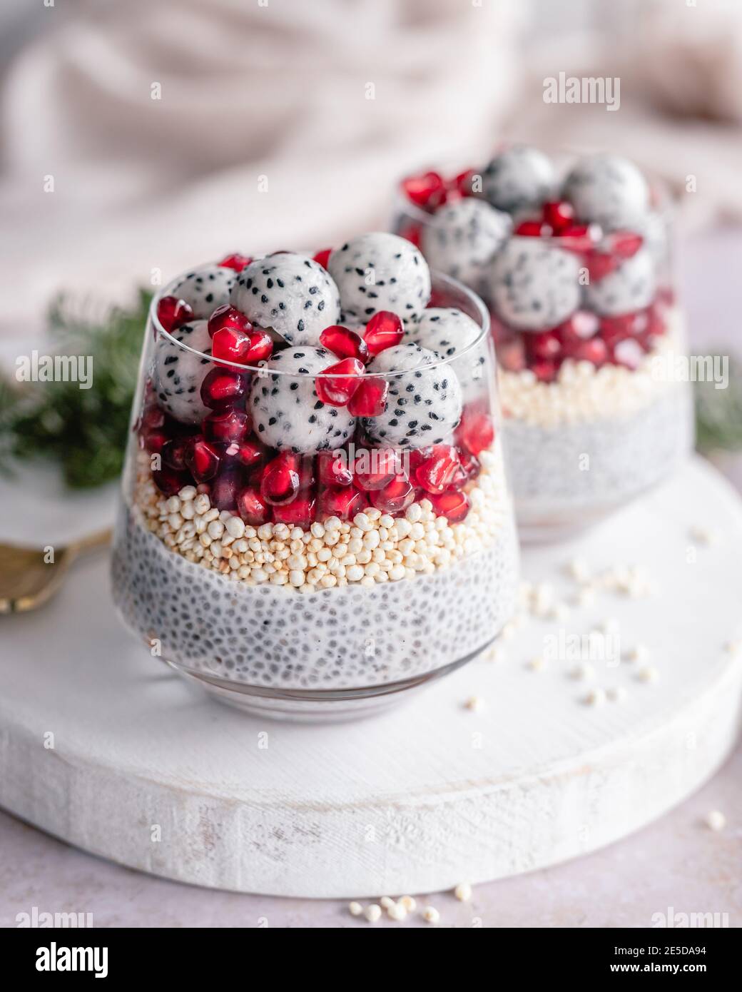 Two Chia pudding desserts with puffed quinoa, pomegranate and dragon fruit balls Stock Photo