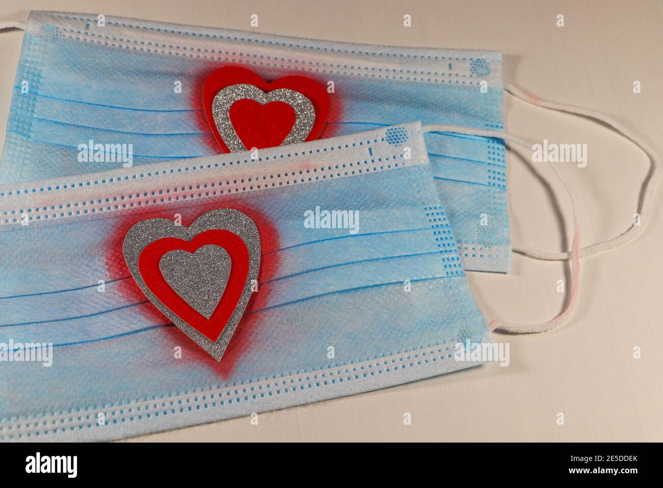 Red And Silver Hearts On Medical Facemasks Stock Photo