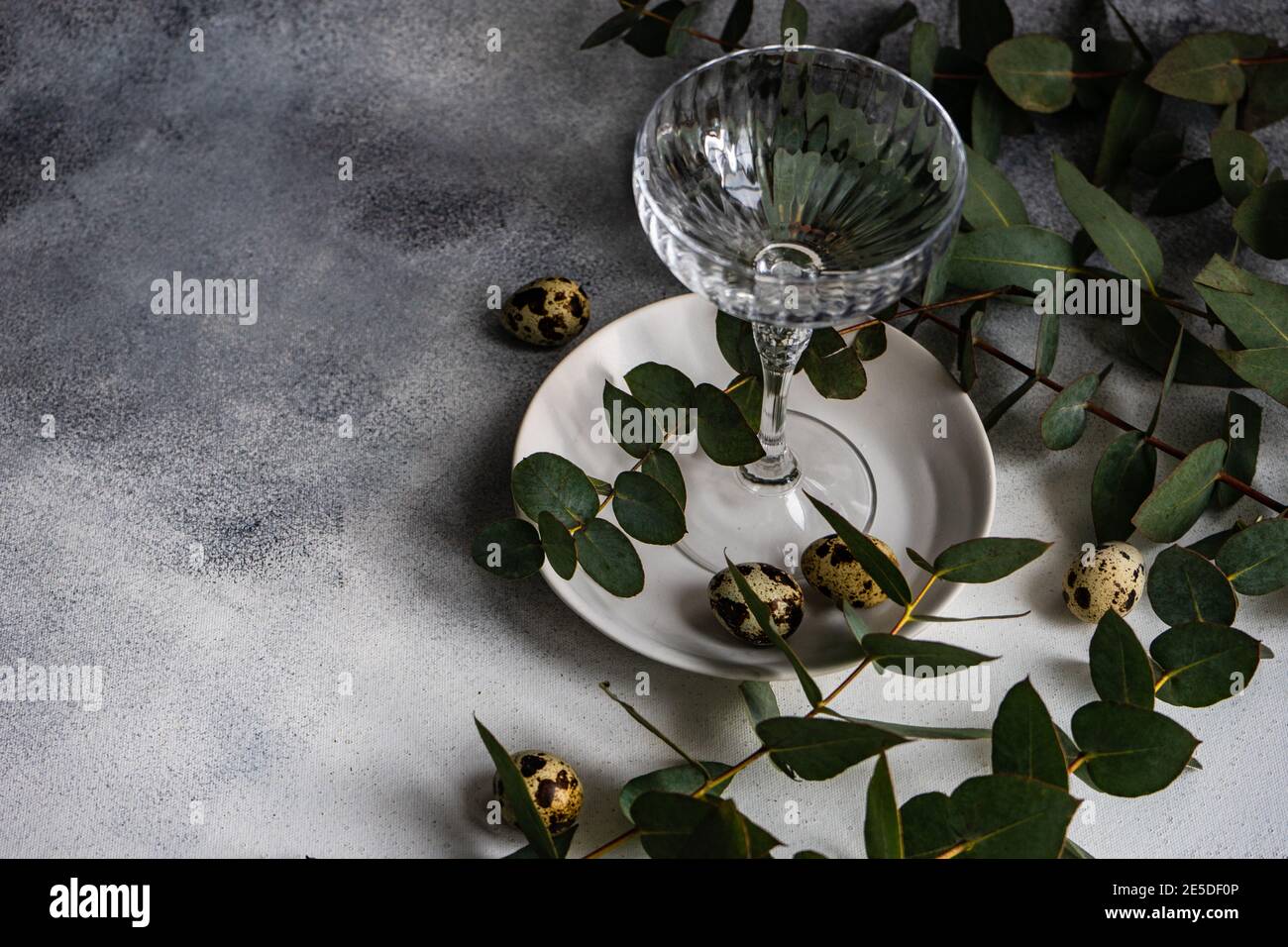 Easter table setting with Easter eggs and eucalyptus stems Stock Photo