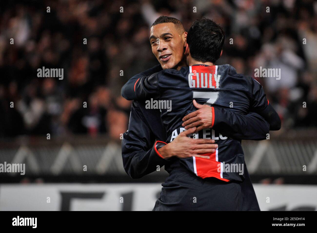 PSG's Ludovic Giuly celebrates with his teammate Guillaume Hoarau after