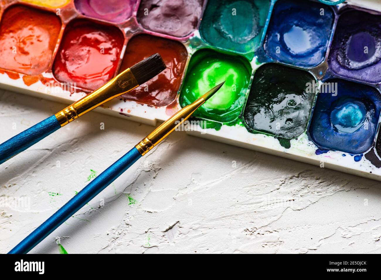 Two paint brushes and a palette with watercolour paints Stock Photo