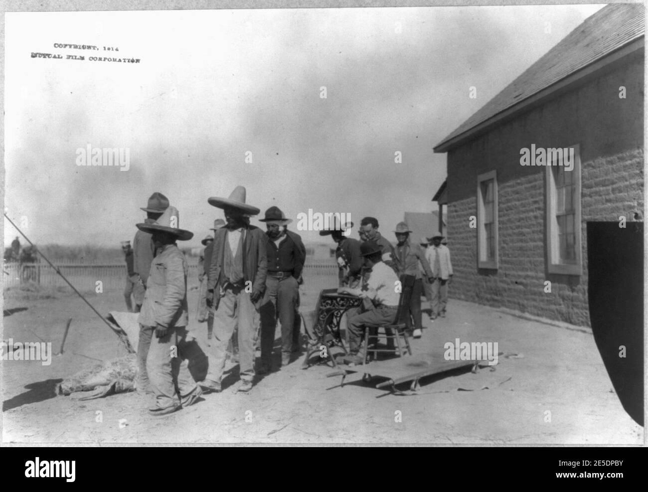 Mexican War, 1914 U.S. soldiers interviewing Mexican refugees; man wearing bowler hat and Red