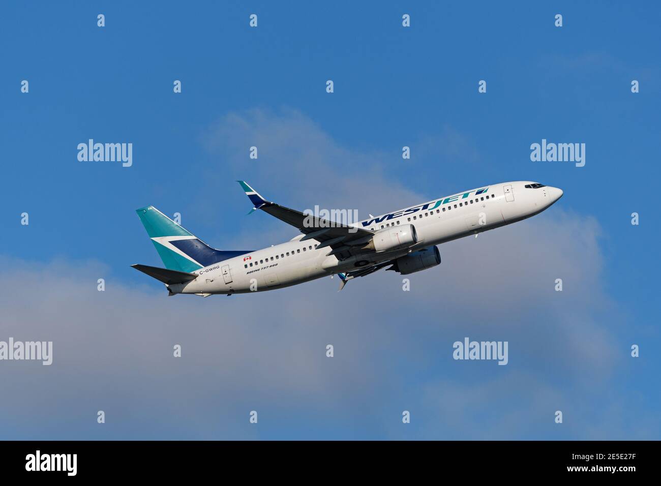 A WestJet Airlines Boeing 737-800 jetliner (C-GWRG) airborne after departure from Vancouver International Airport. Stock Photo