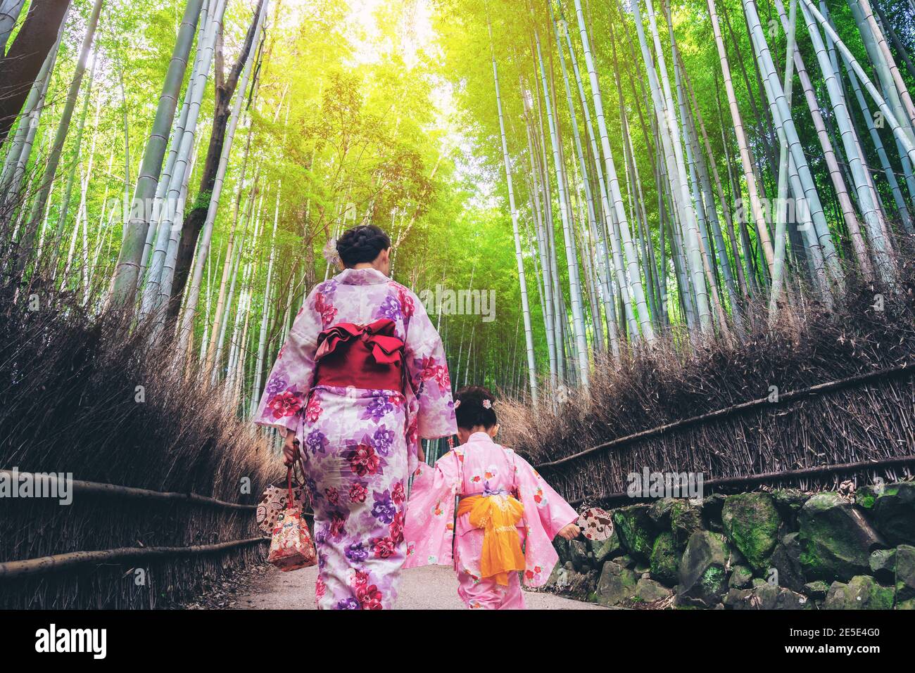 Kyoto, Japan Culture Travel - Asian traveler wearing traditional Japanese kimono walking in Arashiyama Bamboo Forest Grove in the old town of Kyoto Stock Photo